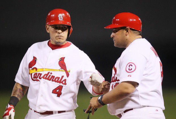 Yadi fist bumps brother Bengie Molina in game vs. Royals on May 30, 2013